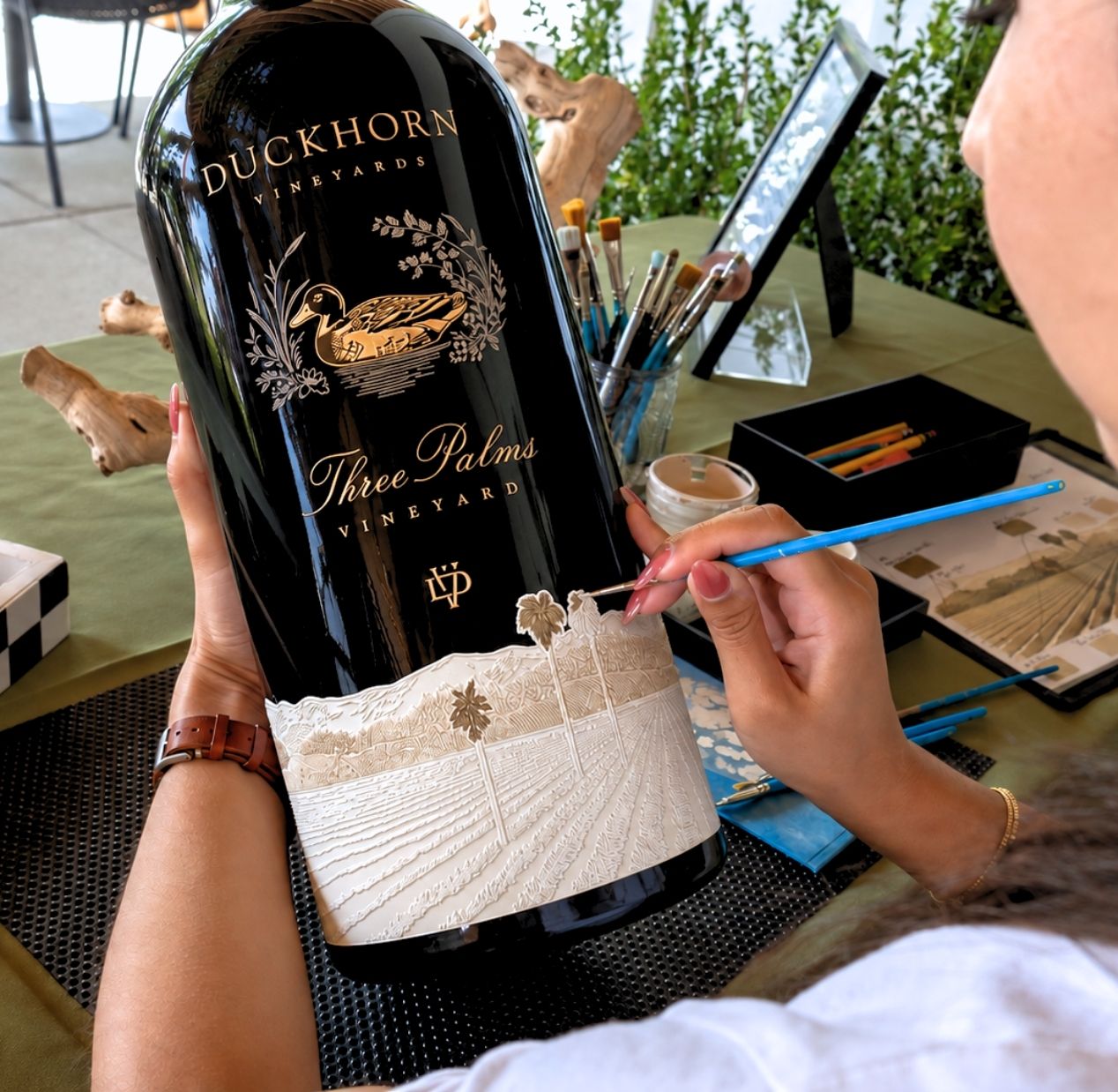 The Duckhorn Collection's Annual Derby Event live painting on wine bottle